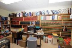 French doors open to this closet, currently a law library and measures 20 x 7. A future lower level kitchen?