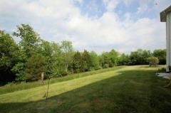 This custom home overlooks mature trees that will allow you to watch the seasons change and offer you the privacy you desire.
