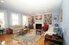 Hardwood floors extend throughout every room except the kitchen in this sprawling ranch. This inviting Living Room includes plenty of recessed lighting, built-in bookcases and the warmth of an oversize gas fireplace.