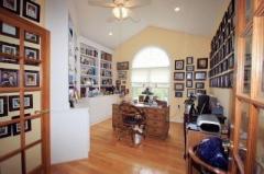 A wall of bookcases and vaulted ceiling enhance the Study that is tucked away for privacy.