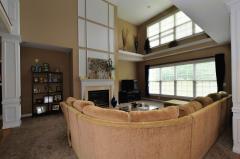 A wall of windows, marble gas fireplace and amazing plush carpet makes this comfortable room a perfect gathering place.