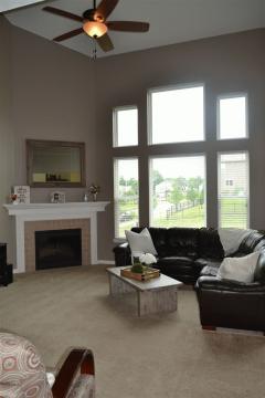 What a statement! Open floorplan is enhanced with soaring ceilings and a gorgeous fireplace and mantle.