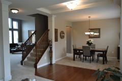 What a beautiful entrance with hardwood floors and tall ceilings that lead to a view of the wall of windows in the 2 story foyer.