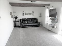 Comfortable Great Room with Beamed Ceilings for some Fun Design! Double Doors to the Deck to Enjoy the Peaceful Lake Lot!