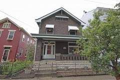 Solid brick home with large inviting covered front porch.