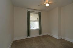 Ceiling fan, window treatments, and wall to wall carpet. would make a great home office.