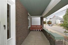Relaxing covered front porch with a porch swing.