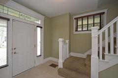 Grand foyer with tile floor and good amount of natural light.