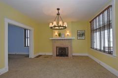 Look at that gorgeous Rookwood fireplace. Hardwood under the carpet and two sets of pocket doors.