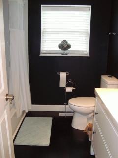 AWESOME UPDATED HALL BATH WITH NEW BAMBO FLOORING*NEW VANITY AND TOP*NEW ELONGATED RAISED COMMODE*NEW CERAMIC TILE TUB SHOWER SURROUND*LINEN CLOSET*BLACK AND WHITE***BEAUTIFUL
