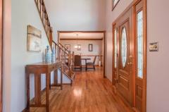 Welcoming foyer features new light fixture, fresh paint, and lots of natural light.