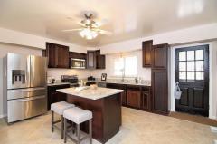 The eat-in kitchen features an island and stainless steel appliances.