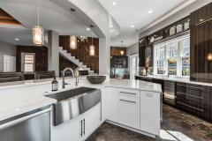 Featuring a stainless farmhouse style sink and a gorgeous expanse of Cambria White Cliffs Quartz, this is where art meets function. Beautiful design and well-equipped to create both amazing memories and food!