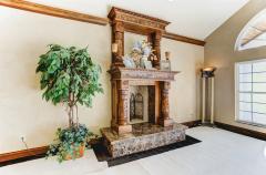 Beautiful Carved Wood Mantel and Wood Burning Fireplace.
