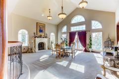 Bright and Enormous Formal Dining Room with Gorgeous views of the Lake and Beautiful Stone Mantel and Fireplace