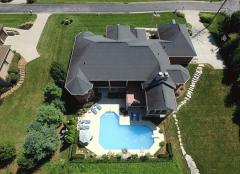 A view from above showcases the fantastic outdoor living and pool area to the rear of this residence