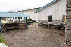 Adjacent to the home and barn is the large stone entertainment area. Hosting the Texas style grill out is now a reality with 100 guests if you choose!