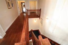 natural wood work hall to master, laundry, mudd room and laundry. Carpeted stairs