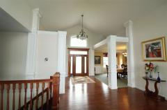 Beveled glass door with side lights and arched window over entry. guest closet