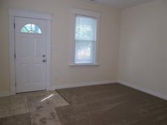 Living room area with new carpet, windows! Freshly painted!