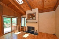 Large add on great room with cathedral ceilings, wood flooring, fireplace and skylights, just waiting for your design touch.