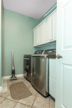 Laundry room is located on the first floor in the mudroom separating the house from the THREE CAR GARAGE!