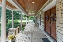 Covered porch stretches the length of the front of the house. You will love the outdoor spaces that this house has to offer.