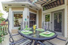 Right outside the kitchen this dining area offers additional space for entertaining. Cool off with the retractable awning installed above the doors into the home.