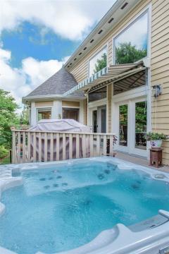 Hot tub has easy access to the screened in porch, right on the deck.