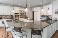 This gourmet home has it all! Custom cabinetry, granite counter tops, counter bar, gorgeous eat in breakfast area, all with a breathtaking view of the backyard.