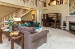 Living room offers ample space to cater to a wide array of furniture. Huge wall of windows bring in tons of natural light. Corner fireplace stretches the height of the two story living room.