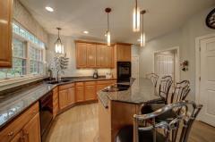 Ceiling fan with light and wall to wall carpet provides additional coziness.