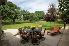 Bring the entertainment outdoors for so much fun under this covered patio with tiled floor, ceiling fans and stone wood burning fireplace.